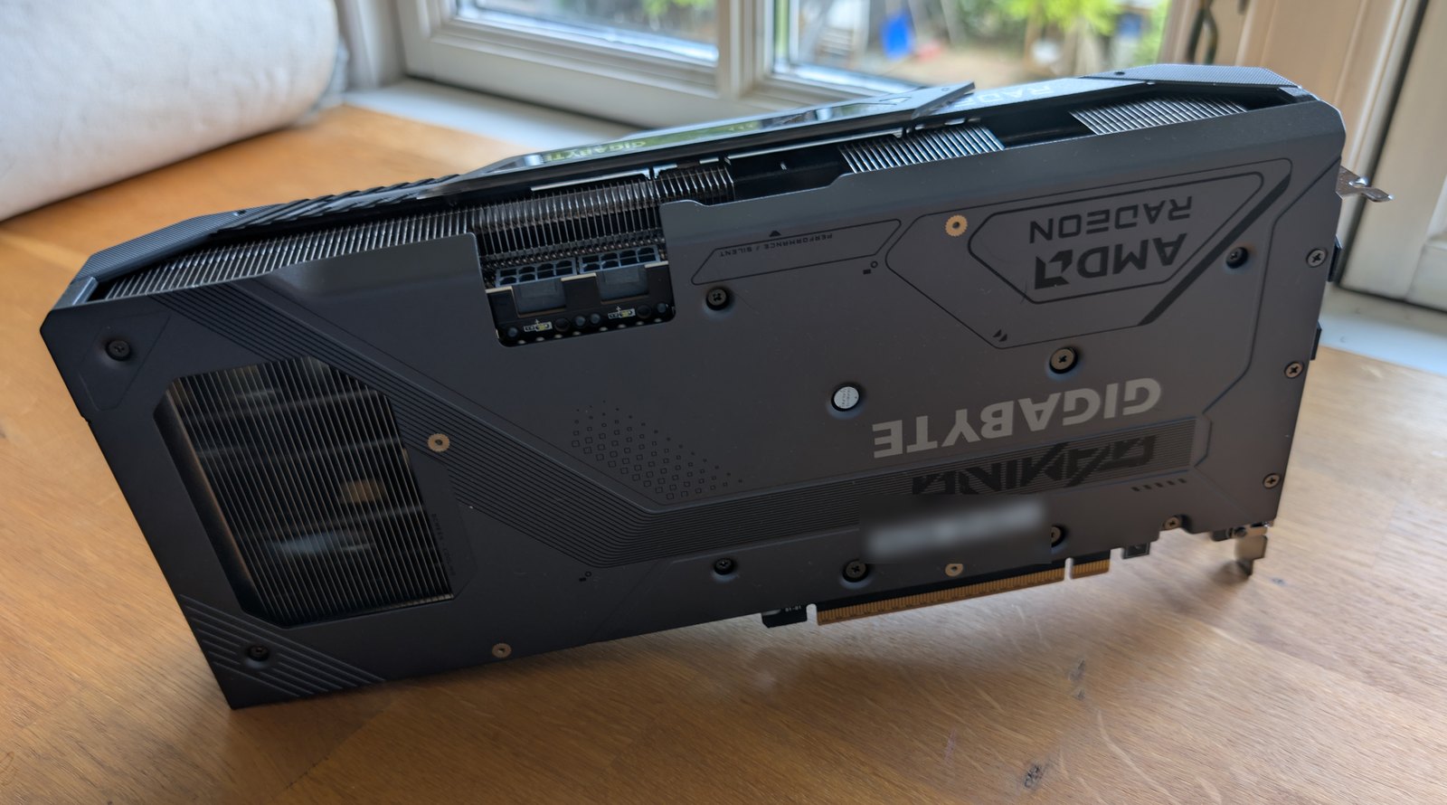 Backplate of the GIGABYTE Radeon RX 9070 GAMING OC, showing the AMD Radeon and GIGABYTE GAMING branding.